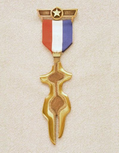 piece meda: female figure, 1974, brass, fabric